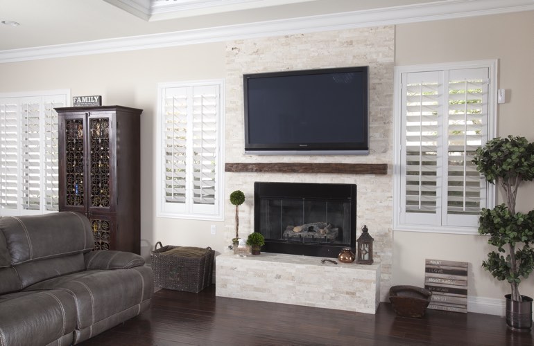 White plantation shutters in a Sacramento living room with solid hardwood floors.